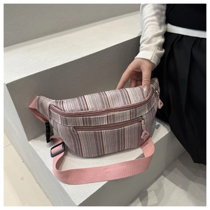 Detailed view of pink and white striped canvas waist bag with adjustable strap and zippers