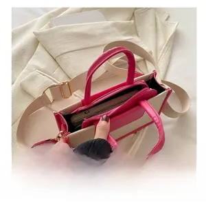 Internal view of beige canvas tote with pink leather dividers and wide fabric strap
