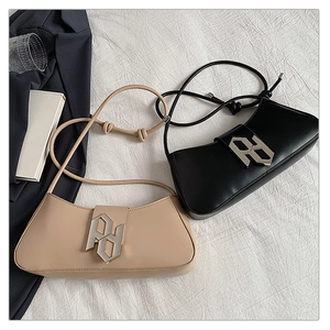 Detail of minimalist leather shoulder bags in black and beige with large geometric buckles