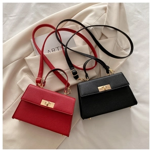 Detailed close-up of textured pebble leather handbags with gold metal twist-lock closures