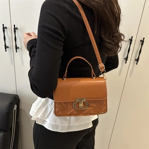 Brown leather handbag for women featuring a woven texture and golden T-lock clasp