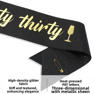 Detail of black glitter sash with golden 'Dirty Thirty' text and metallic safety pin