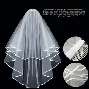 Detailed view of two-layer white bridal veil with satin edge and hair comb 60/80cm