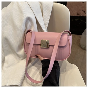 Detail of pink shoulder bag featuring a gold square metallic clasp and faux leather texture