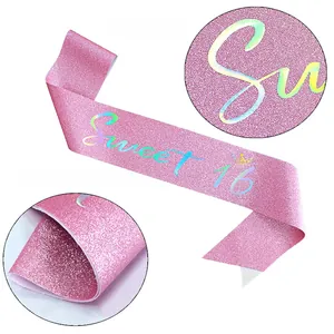 Detail of pink glitter Sweet 16 sash showing shimmering fabric and gold foil printing
