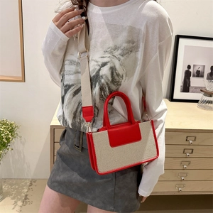 Contrast color canvas crossbody bag with red leather trim and wide adjustable strap