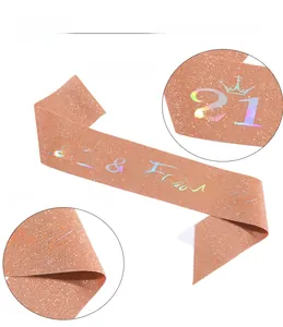 Detail of rose gold glitter sash with iridescent 21 & Fabulous text and crown motif