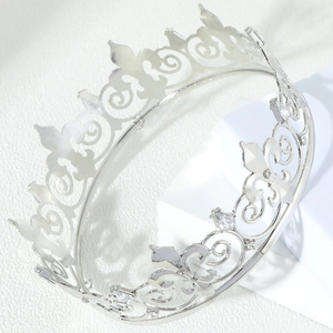 Detailed view of silver-plated alloy crown with intricate fleur-de-lis and rhinestone accents