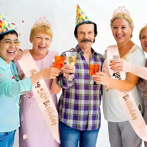Rose gold 50th birthday party set with rhinestone tiaras and pink glitter sashes