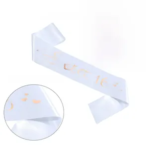 Detail showing white satin Sweet 16 sash with rose gold foil lettering and crown