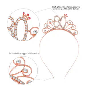 Close-up of rose gold 80th birthday crown with white rhinestones and red details