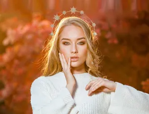 Elegant gold star headband with crystals worn by a model in an autumn forest setting