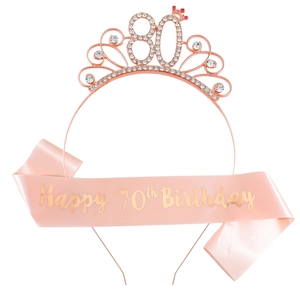 Detail of rose gold 80th birthday crown with rhinestones and pink satin 70th birthday sash