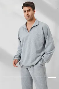 Close-up of a men's gray half-zip sweatshirt featuring a stand collar and dropped shoulders