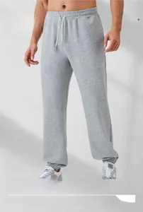 Close-up of light gray men's joggers featuring elastic waistband and white drawstring detail