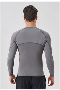Back view of gray athletic compression shirt showing breathable mesh stitching detail