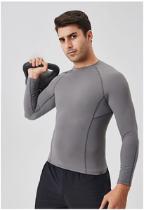 Detail of grey compression shirt showing reinforced stitching and breathable fabric