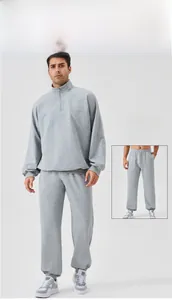 Detail of light gray men's half-zip sweatshirt and matching drawstring jogger set