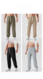 Detail view of men's athletic joggers in khaki, camel, black, and grey with ribbed cuffs