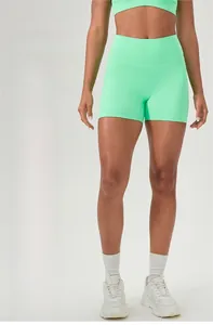 Detail of high-waisted fluorescent green yoga shorts featuring scrunch butt lifting texture
