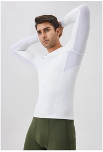 Detail of white compression shirt with mesh ventilation panels and green gym leggings