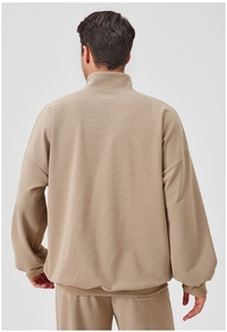 Rear view of men's loose quarter-zip tracksuit featuring ribbed cuffs and hem in khaki