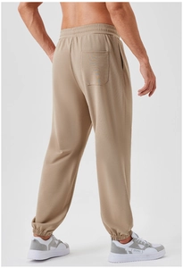 Detail view of khaki joggers featuring rear pocket design and elastic cuff for men