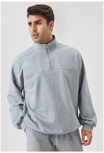 Detail of grey quarter-zip men's athletic sweatshirt with soft knit fabric texture