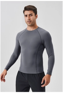 Detail of men's grey compression shirt featuring breathable mesh panels and raglan sleeves