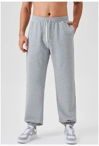 Detail of men's grey jogger sweatpants showing the elastic waistband and white drawstring