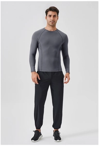 Front view of men's athletic set featuring dark gray compression top and black pants