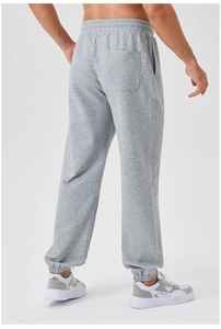 Detail of men's grey sweatpants showing elastic drawstring waist and back pocket