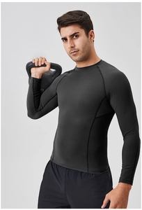 Close-up of black compression shirt showing ergonomic stitching and moisture-wicking fabric