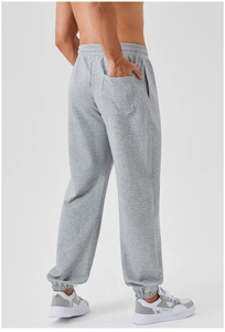 Detail of men's grey jogger pants showing the elastic waist and single back pocket