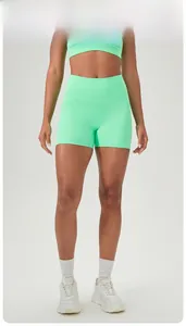 Detail of high-waisted mint green fitness shorts with elastic moisture-wicking fabric