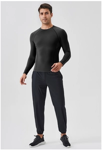 Mens compression workout suit with tight long sleeve top and athletic pants for running