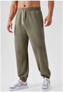 Detail of men's athletic joggers with drawstring elastic waist and ribbed cuffs