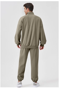 Rear view of olive green men's track suit showing relaxed fit and high collar design