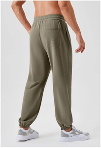 Close-up of olive green jogger pants for men featuring a textured waffle knit fabric