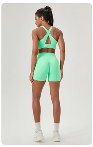 Close-up of mint green high waist yoga shorts with scrunch butt lifting detail and cross back bra