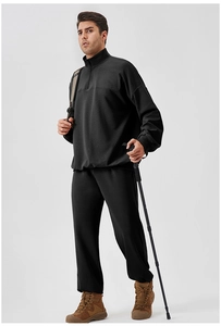 Detail of men's black waffle texture sports suit with half-zip top for hiking and fitness
