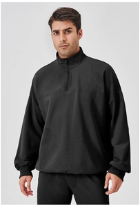 Detail of men's quarter-zip sports sweatshirt showing vertical striped knit fabric texture