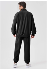 Back view of men's black sports tracksuit with stand collar and loose-fit jogging pants