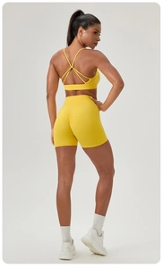 Rear view of high-waist yoga shorts with scrunch detail and strappy sports bra set