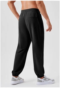 Rear view of black men's joggers showing elastic waistband and functional back pocket
