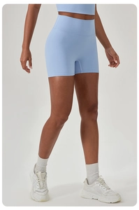 Detail of high-waist light blue yoga shorts with stretchy fabric and seamless design