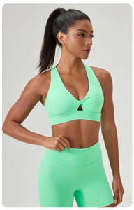 Mint green yoga set featuring a v-neck sports bra with knot detail and high waist shorts