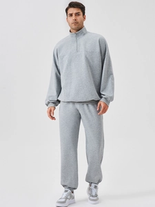 Men's grey two-piece tracksuit with half-zip sweatshirt and matching sweatpants