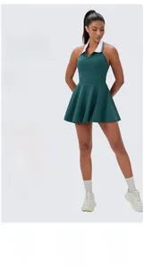 Detail of green athletic dress showing four-way stretch fabric and pleated hemline