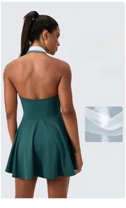 Halter neck detail of dark green tennis dress with open back and breathable fabric texture